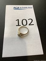 Top-down view of ring placed on paper with lot number visible
