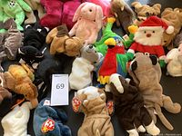 Overview of 18 assorted Ty Beanie Babies plush toys including various animals and one Santa Claus in red hat.