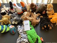 Lot of assorted Beanie Babies plush toys from various angles showing collection size and condition.