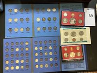 Full view of all coin folders and proof sets showing multiple slots for coins and several inserted coins.