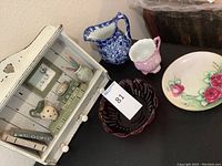 Photo showing ceramic pitcher, sugar bowl, red glass candy dish, Bavarian China plate, and small teapot charm grouped together.