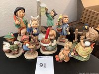 Complete group of 10 Hummel Goebel ceramic statues showing all figurines grouped together.