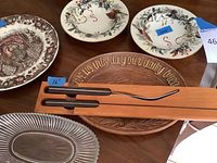 Lot overview showing all items including Lenox plates, Johnson Bros. plate, wooden bread tray, glass dish, and carving set