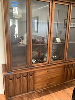 Front view showing upper glass display doors and lower drawers