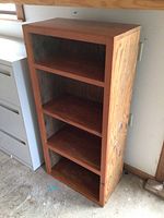 Front view of the four-shelf solid wood bookcase, showing rectangular shape and open shelving.
