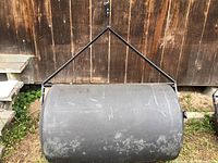 Front view showing large cylindrical drum and metal pull handle