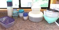 Overall view of all food storage containers and strainers on countertop