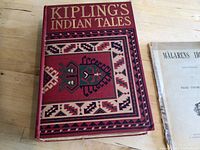 Front cover of Kipling's Indian Tales hardcover book displaying a unique geometric patterned design and title in gold embossed text.