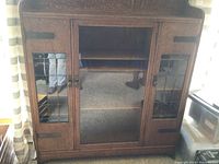 Front view of oak leaded glass cabinet with central glass door and two side leaded glass doors.