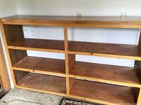 Front view of the pine shelving unit showcasing six shelves with closed back and sides.