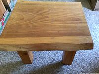 Top view of the solid pine coffee table showing the natural wood grain and irregular shape of the top surface.