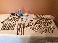 Overview of entire flatware layout including spoons, forks, knives and accessories