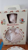 Original Bunnykins packaging box with Bunnykins artwork and cutout windows showing wrapped dishware inside.