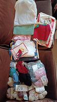 Photo showing stacked assorted fabric pieces and some lace trims, multiple colors and patterns visible