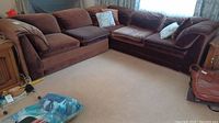 Full view of the chocolate brown 2-piece sectional sofa in an L shape with cushions and throw pillows.