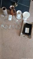 Full assortment of vases and decorative tray laid on the floor showing all pieces included in the lot.
