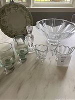 Photo showing all items including crystal bowl, candlestick, cream and sugar set, plate and goblets on table