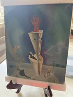 Salvador Dali art print in packaging showing a surreal artwork on a stand
