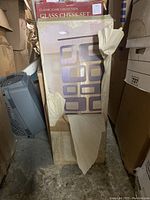 Boxed decorative panel with visible rectangular cutouts, likely made of wood or fiberboard, showing proof of Art Deco style design with geometric patterns.