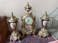 Full three-piece mantel clock garniture set on table