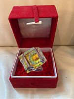 Crystal cube inside original red velvet box with white interior padding and red fabric lining