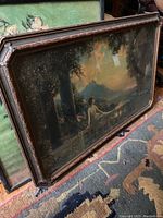 Photo showing painting leaning against a wall, highlighting overall condition and frame details