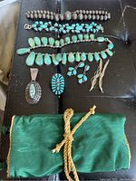 Top view of all jewelry pieces laid out on black surface