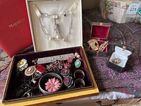 Full image of assorted jewelry along with Majolica necklace box and additional small boxes with rings and pins