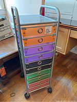 Front view of the rolling cart organizer showing 10 colorful drawers and metal frame with caster wheels.