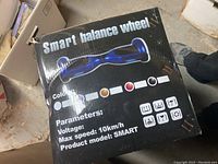 Top view of the product box showing the product name Smart Balance Wheel, illustration of the hoverboard, color options, and product parameters including voltage and max speed of 10 km/h.
