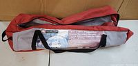 Red and gray carrying bag with label indicating 13ft x 9ft Dome Screen House tent by Ecosense.