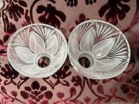 Pair of glass lampshades viewed from top showing the circular opening and symmetrical leaf and fan motifs etched and frosted into the glass.