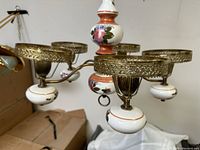 Wide view to show multiple arms and porcelain details of the antique light fixture.