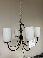 Four-light hanging chandelier shown from a distance, displaying the overall design and chain attachment.