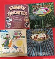 Photo of 4 vinyl album covers: Funky Favorites, Peter Pan, Mary Poppins, Bambi, showing front covers with colorful illustrations and titles.