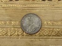 Close-up image of the 1936 Canada silver dollar coin showing King George V portrait and the surrounding inscriptions.