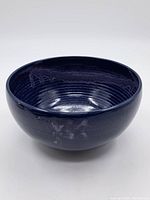 Blue glazed ceramic bowl, showing general shape and exterior finish with subtle marks indicating vintage condition.