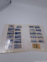 Two binder pages containing collectible cards with WWII aircraft and naval ships bearing the Daily Mail logo.