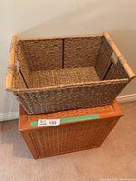 Wicker basket shown on top of wooden hamper
