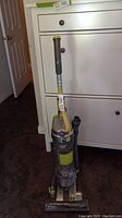 Front view of Hoover Air vacuum showing handle, dust canister, and base