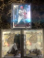 Front view of three Bowman Chrome MLB rookie cards: one Elly De La Cruz Cincinnati Reds card and two K. Bryan Hayes Pittsburgh Pirates cards with reflective chrome finish.