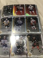 Page of Upper Deck NHL hockey cards showing players such as Brad Marchand, Sidney Crosby, Connor McDavid, Nicklas Backstrom, Dougie Hamilton with holographic finishes
