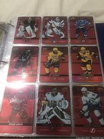 Page of hockey cards with red parallel design featuring Carey Price, Henrik Lundqvist, Marc-Andre Fleury, Sidney Crosby, P.K. Subban, and others.
