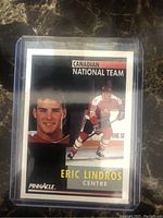 Front of Eric Lindros 1990 Pinnacle Canadian National Team hockey card showing action and headshot.