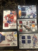 Five NHL memorabilia hockey cards showing jersey swatches from players including Alex Galchenyuk, Roberto Luongo, Drew Doughty, Henrik Lundqvist, and Klein Merson.