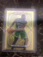 Front side of the basketball card showing Tristan Thompson in a Boston Celtics uniform with yellow electric etch prizm flood design.