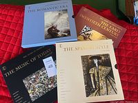 Four classic LP albums: The Romantic Era (blue cover), The Early Twentieth Century (dark red/orange cover), The Music of Today (black cover), and The Spanish Style (cream cover). Visible condition and artwork.