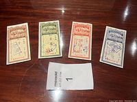 Four vintage Chinese certificates of deposit displayed on a wooden surface with a MaxSold lot tag labeled '1'. The certificates show various colors and stamps.