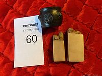 Photo of set including two carved stone seals and one bronze incense burner with MaxSold lot card