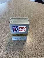 Front and top views of the 1990 Pro Set PGA Tour Special Inaugural Set box, sealed in shrink wrap.